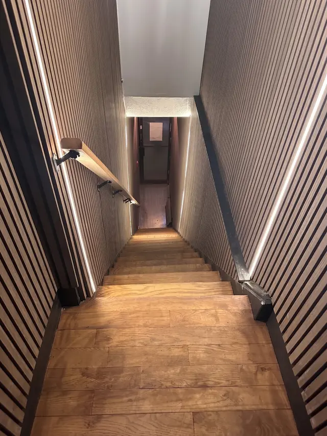 Lounge renovation, after: slat wall stairwell led lighting