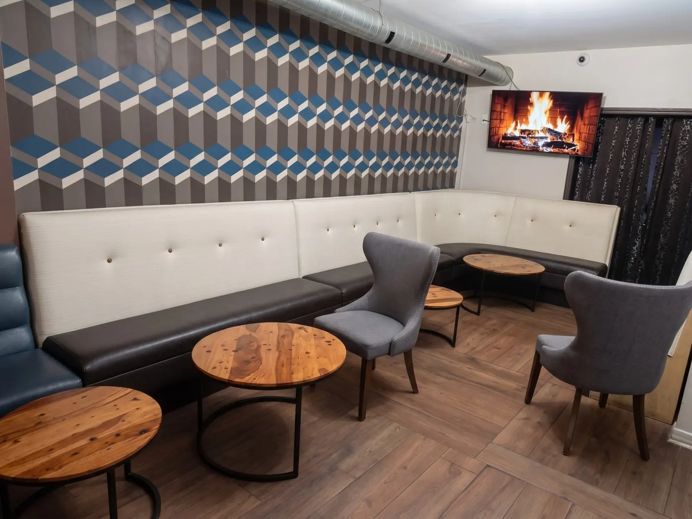 Lounge renovation, after: geometric accent wall banquette